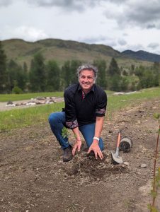 Roly Russell planting a tree